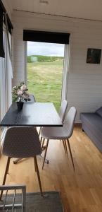 a table and chairs in a room with a window at Studlagil Canyon Country Home in Grund