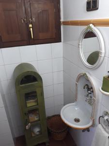 ein Bad mit einem Waschbecken und einem Spiegel in der Unterkunft La Casina de Abo in El Manto