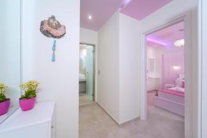 a white room with a mirror and a bedroom at Dream View in Skala Marion +64 photos