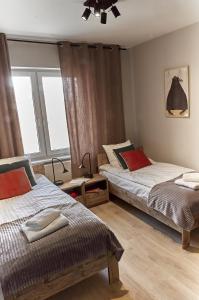 Łóżko lub łóżka w pokoju w obiekcie Między Nami Apartamenty