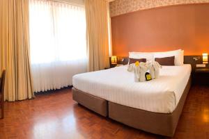 Кровать или кровати в номере Hotel M Chiang Mai