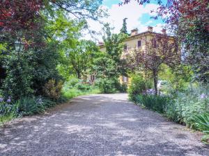 a road in front of a house with flowers at Villa Brizzi in San Lazzaro di Savena