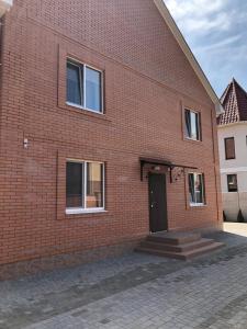 a red brick building with a black door at Apartments IRIS in Chornomorsk