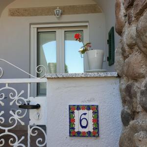 a house with a window with a number on it at Borgo Antico in Marciana Marina