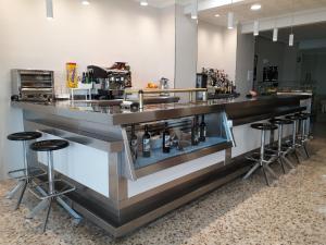 a bar with a row of stools around it at Hostal Moreno in Silla