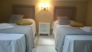 Cama o camas de una habitación en Casa de Huéspedes Vecinodecerbantes