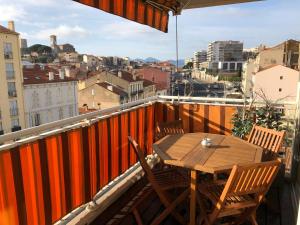 Una mesa y sillas en un balcón con vista. en appartement vue mer, en Cannes