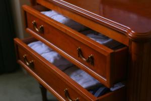 a drawer of a dresser with towels in it at Hotel Marital Sousei Kurume in Kurume