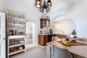 a kitchen with a table with bananas on it at 180° Caldera by Stylish Stays in Firostefani