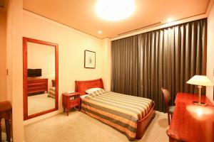 a hotel room with a bed and a mirror at Hotel Marital Sousei Kurume in Kurume