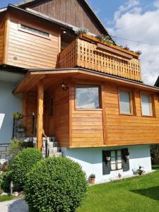a house with a balcony on top of it at Apartment KAYA in Mojstrana