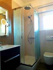 a bathroom with a shower and a toilet and a sink at Apartman - The view in Krk +23 photos