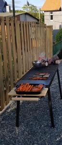 a grill with hot dogs and a bowl on it at Haus Sonnblick in Braunlage