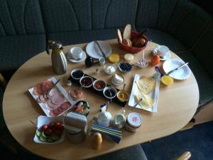 a wooden table with plates and food on it at Mertens in Soltau