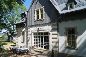 Casa blanca con mesa y sillas en Villa Unger, en Kurort Altenberg