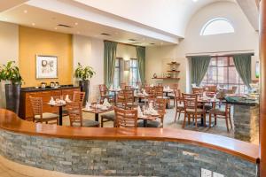a restaurant with tables and chairs and a bar at Town Lodge Roodepoort in Roodepoort