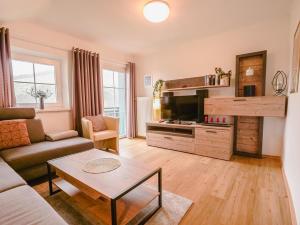 a living room with a couch and a table at Appartement "Haus Lisa" in Ramsau am Dachstein in Ramsau am Dachstein