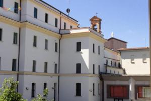a white building with a clock tower on top of it at Residenza Montenevoso in Campobasso