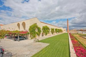 a building with a green lawn in front of it at Bernardas Convent Apartment in Tavira
