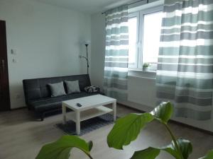 a living room with a couch and a table at Apartmány Stdaniela in Bohumín