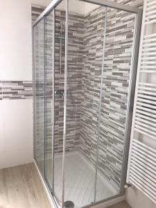 a shower with glass doors in a room at La casa dei butei in Castelnuovo del Garda
