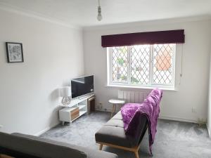 a living room with a couch and a window at One Bedroom Apartment hosted Be More Homely Serviced Accommodation & Apartments Birmingham With X1 King Beds Sleeps 4 in Birmingham