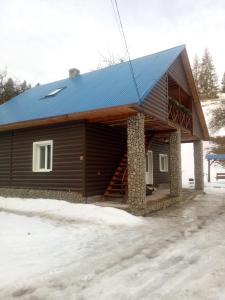 una cabina con tetto blu nella neve di "Відпочинок в Карпатах" a Izki