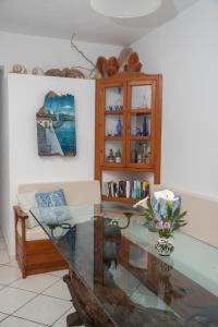 a living room with a glass table and a couch at Pansion Katerina in Skala