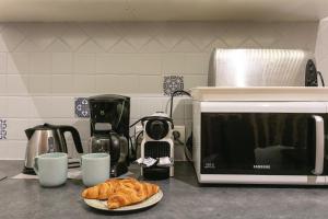 a croissant on a plate next to a microwave at La Ritournelle in Sarlat-la-Canéda