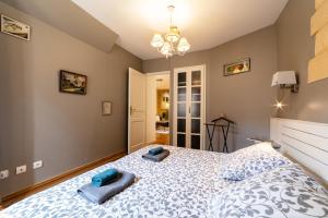 a bedroom with a bed with blue pillows on it at La Ritournelle in Sarlat-la-Canéda