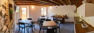 a restaurant with tables and chairs in a room at B&B Da Pieri in San Giovanni Bianco