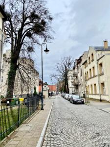 a cobblestone street with a street light and buildings at Dream Apartments Sopot in Sopot