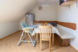 a kitchen with a table and two chairs and a refrigerator at Apartment Jakovc in Bohinj