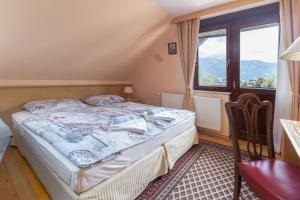 a small bedroom with a bed and a window at Apartment Jakovc in Bohinj