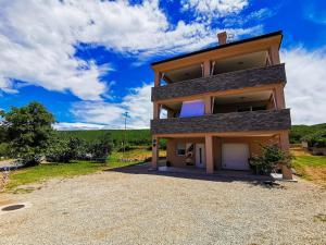 a house on a hill with a driveway at App La Vita e bella - Azzurro in Punat