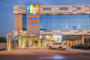 a car parked in a parking lot in front of a hotel at Ewaa Express Hotel - Khurais in Riyadh