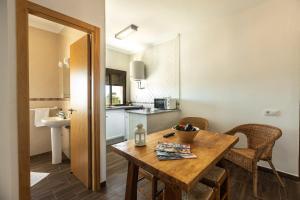 a kitchen and dining room with a wooden table at APARTAMENTO BOLONIA SUR B in Tarifa +12 photos