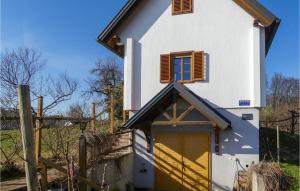a small white house with a yellow garage at Beautiful Home In Strem-sumetendorf With 2 Bedrooms And Wifi in Sumetendorf