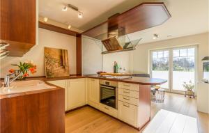 a kitchen with a sink and a stove top oven at Amazing Apartment In Langenhorn With Kitchen in Langenhorn