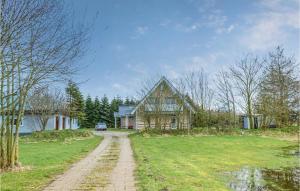 a house with a dirt road in front of a house at Amazing Apartment In Langenhorn With Kitchen in Langenhorn