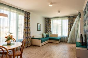 a living room with a couch and a table at Villa Flora in Sozopol