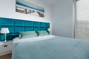 Postel nebo postele na pokoji v ubytování Resort Apartamenty Klifowa Rewal 36