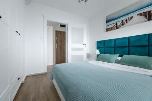Postel nebo postele na pokoji v ubytování Resort Apartamenty Klifowa Rewal 36