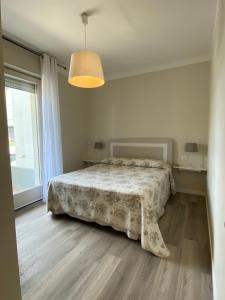 a bedroom with a bed and a large window at Apartments Peninsula in Sirmione