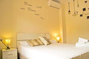 a bedroom with two beds with words on the wall at Roquetas Beach and Playa Serena Golf Village in Roquetas de Mar