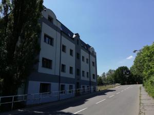 a white building on the side of a road at Apartmány Stdaniela in Bohumín