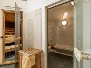 a walk in closet with a glass door at Hotel Waldheim Garni in Mayrhofen