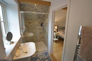 a bathroom with a shower and a sink and a tub at Brook Cottage - Luxury in Mundesley in Mundesley +13 photos