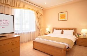 
a bedroom with a large bed and a large window at Marins Park Hotel Rostov in Rostov on Don
