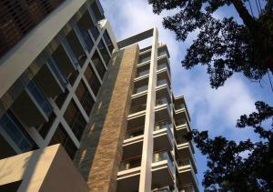 a tall building with balconies on the side of it at Jatra Flagship Dhaka Lake View in Dhaka